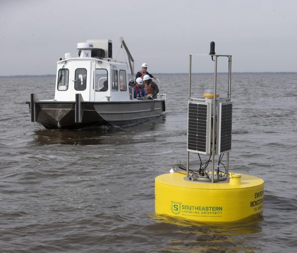 BUOY DEPLOYMENT – Members of the buoy deployment team leave the area after the deployment of one of four buoys in Lake Maurepas. Scientists from Southeastern Louisiana University will be monitoring the marine life populations (fishes, crabs, shrimp), as well as the plant life in the surrounding wetlands, and also watching and studying any variations in water quality with data from the buoys.